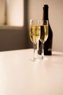 Champagne glasses with bottle white table
