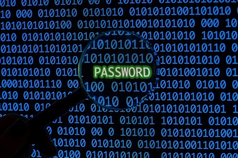 Password with binary code hand holding magnifying glass