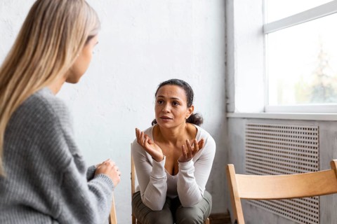 Woman talking about her problems group therapy session