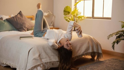 Woman using smartphone home bed. Resolution and high quality beautiful photo