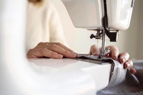 Close up person using sewing machine. Resolution and high quality beautiful photo