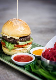 Modern fusion beef burger set with lotus chips ketchup and spicy chlli sauces