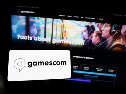 Stuttgart, Germany, 07-15-2023: Person holding smartphone with logo of German video game trade fair