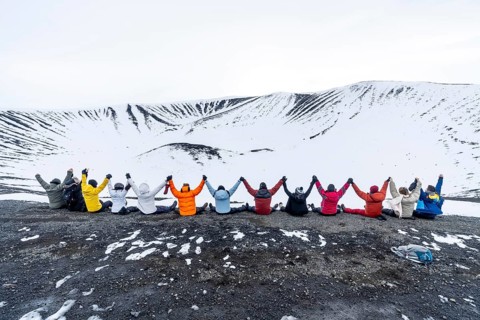 A group of adventurous friends on the Hverfjall volcano in Myvatn Nature Park, Iceland. Concept of