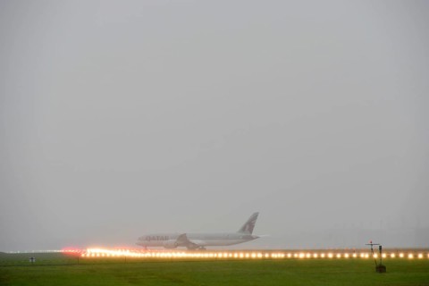 Overview Munich Airport with Qatar Airways, Boeing B787 Dreamliner take-off during thunderstorm,