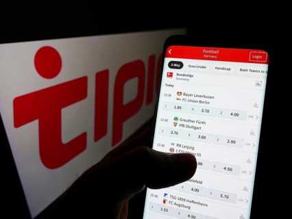 Stuttgart, Germany, 01-08-2022: Person holding smartphone with website of sports betting company