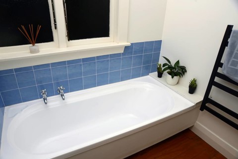 Interior of a retro bathroom with a bathtub and toilet