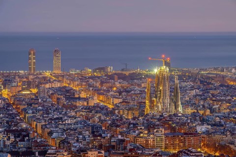 The skyline of Barcelona city centre with the Sagrada Familia in front of sunrise