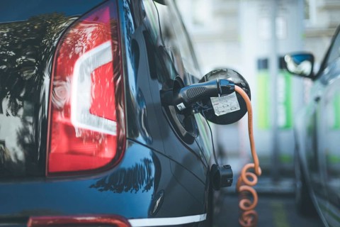 Electric car recharging with charge cable and plug leading to charge point