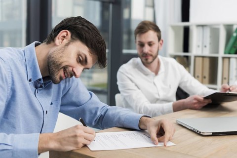 Side view smiley man signing work contract