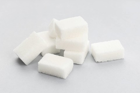 Sugar cubes on gray background. Close up