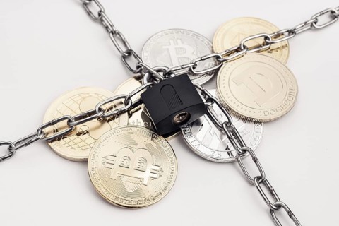Cryptocurrency security concept. Group of crypto coin protected by chain and padlock