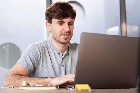 Man working as lancer home his laptop