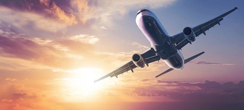 modern airplane against a colorful sky