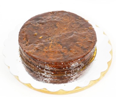 Half stage on sacher torte chocolate cake on silver mirror plate towards white