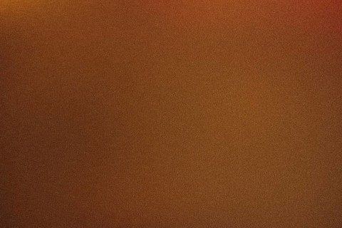 High grain photo of a warm brown gradient, ideal for backgrounds