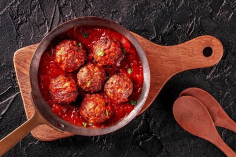 Meatballs. Beef meat balls, overhead flat lay shot in a pan, with parsley and tomato sauce, on a