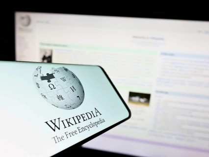 Stuttgart, Germany, 01-08-2023: Smartphone with logo of online encyclopedia Wikipedia on screen in