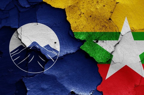 Flags of Kachin State and Myanmar painted on cracked wall