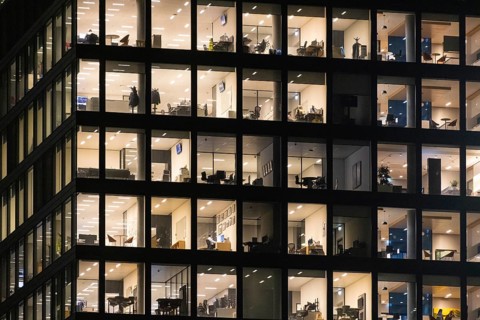 The lights in the offices of the Omni Tower in Frankfurt am Main glow in the evening. Frankfurt am