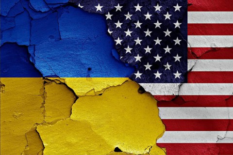 Flags of Ukraine and USA painted on cracked wall