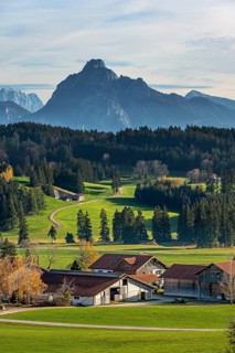 Farms, autumnal meadows and forests near Seeg with the Säuling mountain in the background, Allgäu,