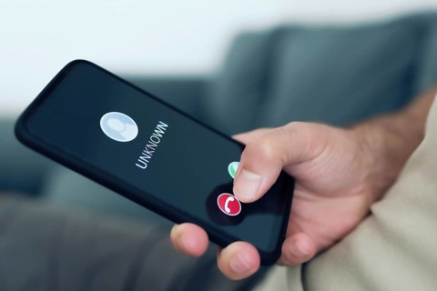 close-up view of person rejecting call from unknown caller or unknown number on smartphone, phone