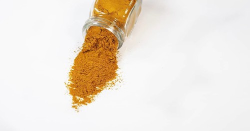 Curry Powder falling against white background