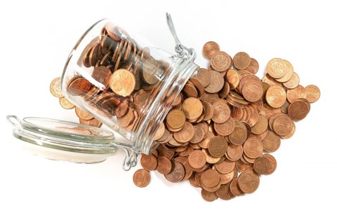 small change euro cent coins pouring out of glass jar isolated on white background, withdrawal of