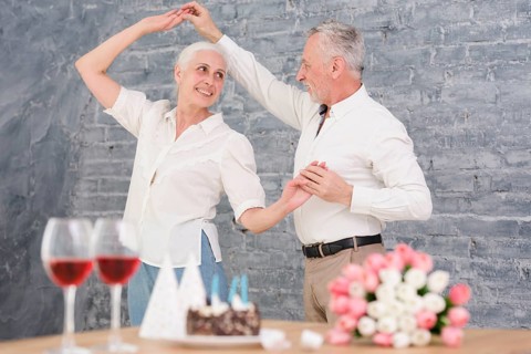 Senior husband wife dancing birthday party
