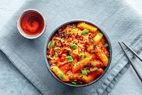 Rabokki, tteokbokki or topokki with ramen, Korean street food, spicy rice cakes, overhead flat lay