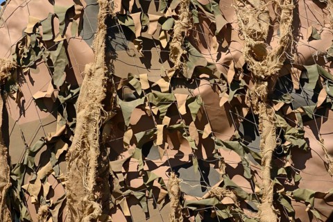 A drab background of army camouflage netting
