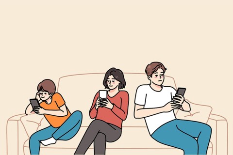 Young family with child sit on sofa browsing internet on modern smartphone. Parents and small kid