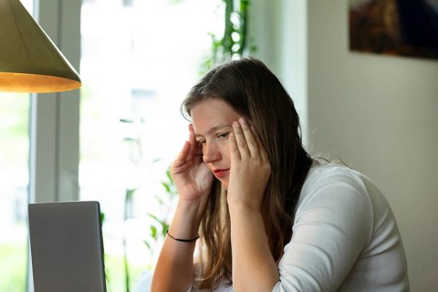 Young woman suffers from burnout in home office on laptop, Freiburg, Baden-Württemberg, Germany,