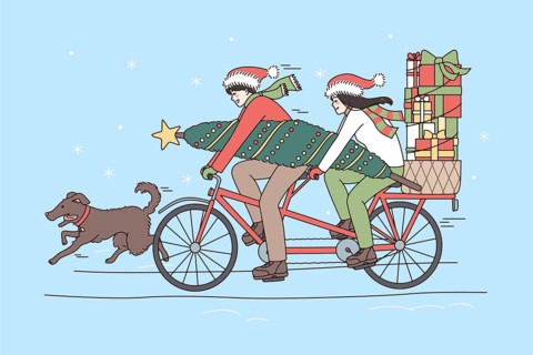 Christmas and New Year holidays concept. Smiling happy couple riding on bicycle with evergreen tree