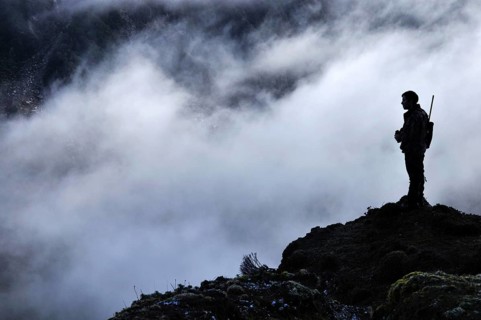 Silhouette of a hunter scoping for Himalayan tahr in the Southern Alps of New Zealand