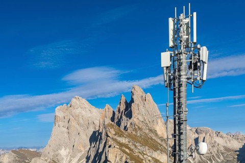 Mobile phone mast in front of mountain peaks in South Tyrol