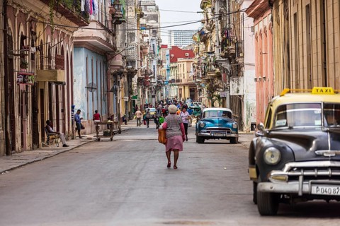 Street scene with vintage taxi car in the old part of the Havana