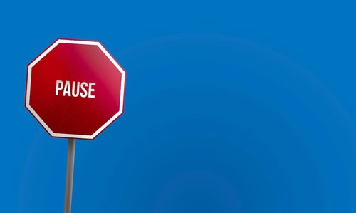 Pause, red sign with blue sky