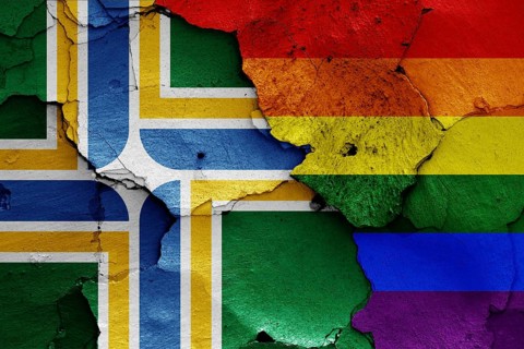 Flags of Portland and LGBT painted on cracked wall