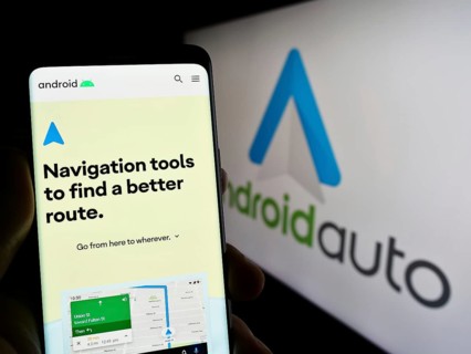 Stuttgart, Germany, 03-14-2023: Person holding smartphone with webpage of mobile app Android Auto