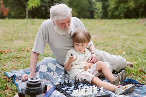 Front view grandson sitting with grandpa
