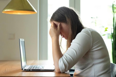 Young woman suffers from burnout in home office on laptop, Freiburg, Baden-Württemberg, Germany,