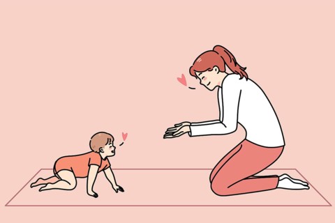 Loving happy young mother play with little toddler crawling at home. Smiling caring mom have fun