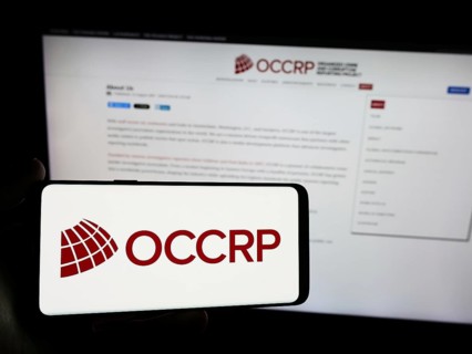 Stuttgart, Germany, 05-22-2024: Person holding smartphone with logo of Organized Crime and