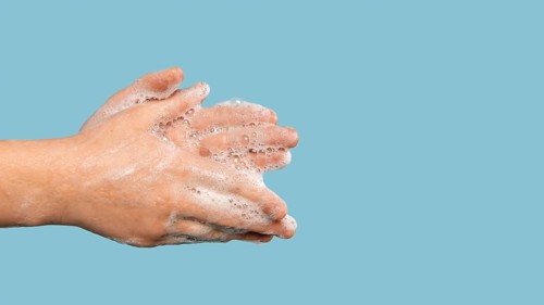 Sideways person washing hands with copy space