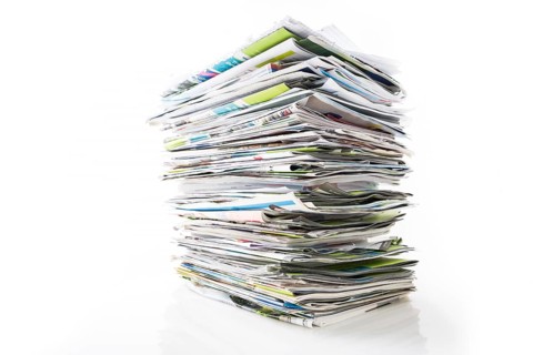 Stack of waste paper, old magazines, newspapers and leaflets for recycling isolated on white