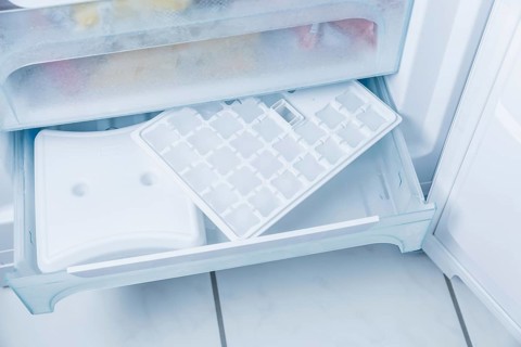 Ice cube maker in modern freezer with no-frost, houseold concept