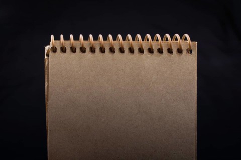 White notebook on a black color background inthe view
