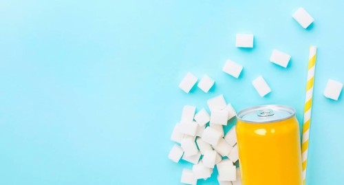 Flat lay soft drink can with sugar cubes straw